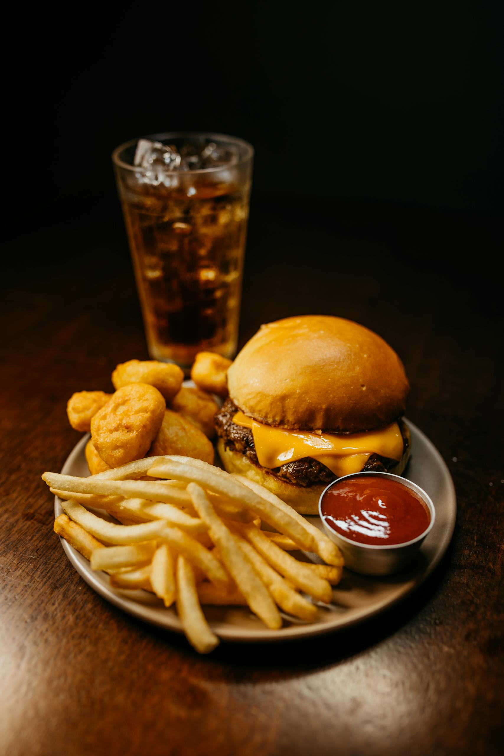 Mouth-watering fast food combo with burger, fries, nuggets, and a refreshing drink.
